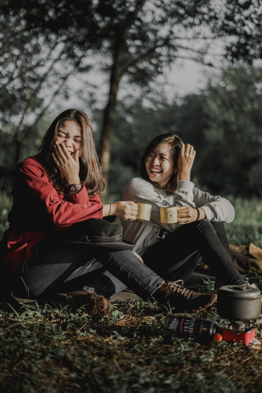 two girls laughing after improving mental health with self-care tips.